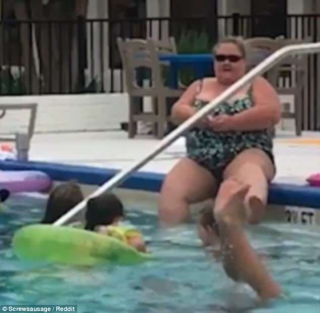 woman shaving legs in pool