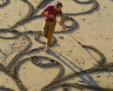 A Man Takes A Single Rake to The Beach. And When You Zoom Out And See It… Mind BLOWN.