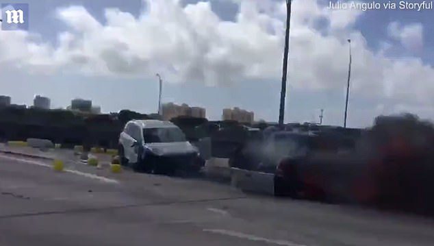 man pulls driver from burning car